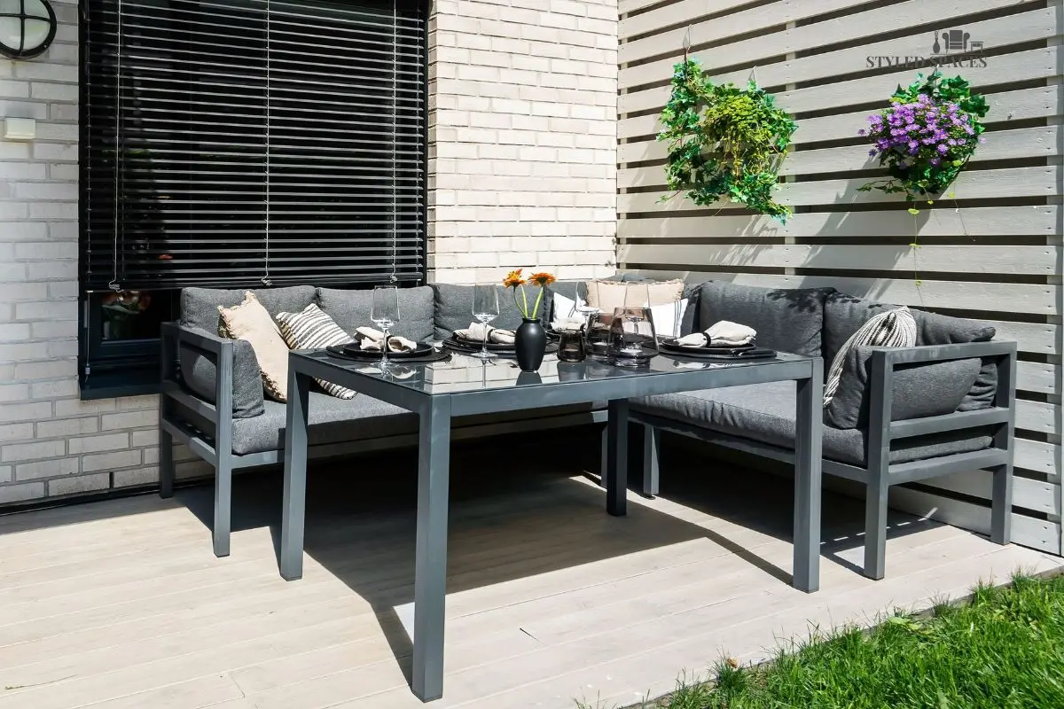 Patio anchored with a deep sofa and coffee table conversation group