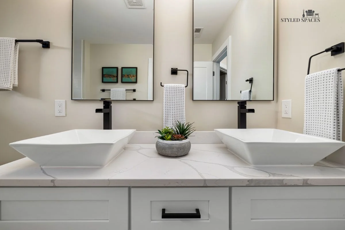 Bathroom with two separate vanities set at different heights instead of one long counter