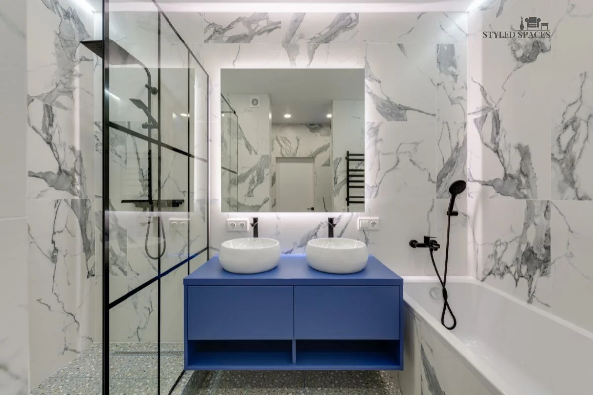 All-white bathroom warmed up with marble texture and a bold pop of color