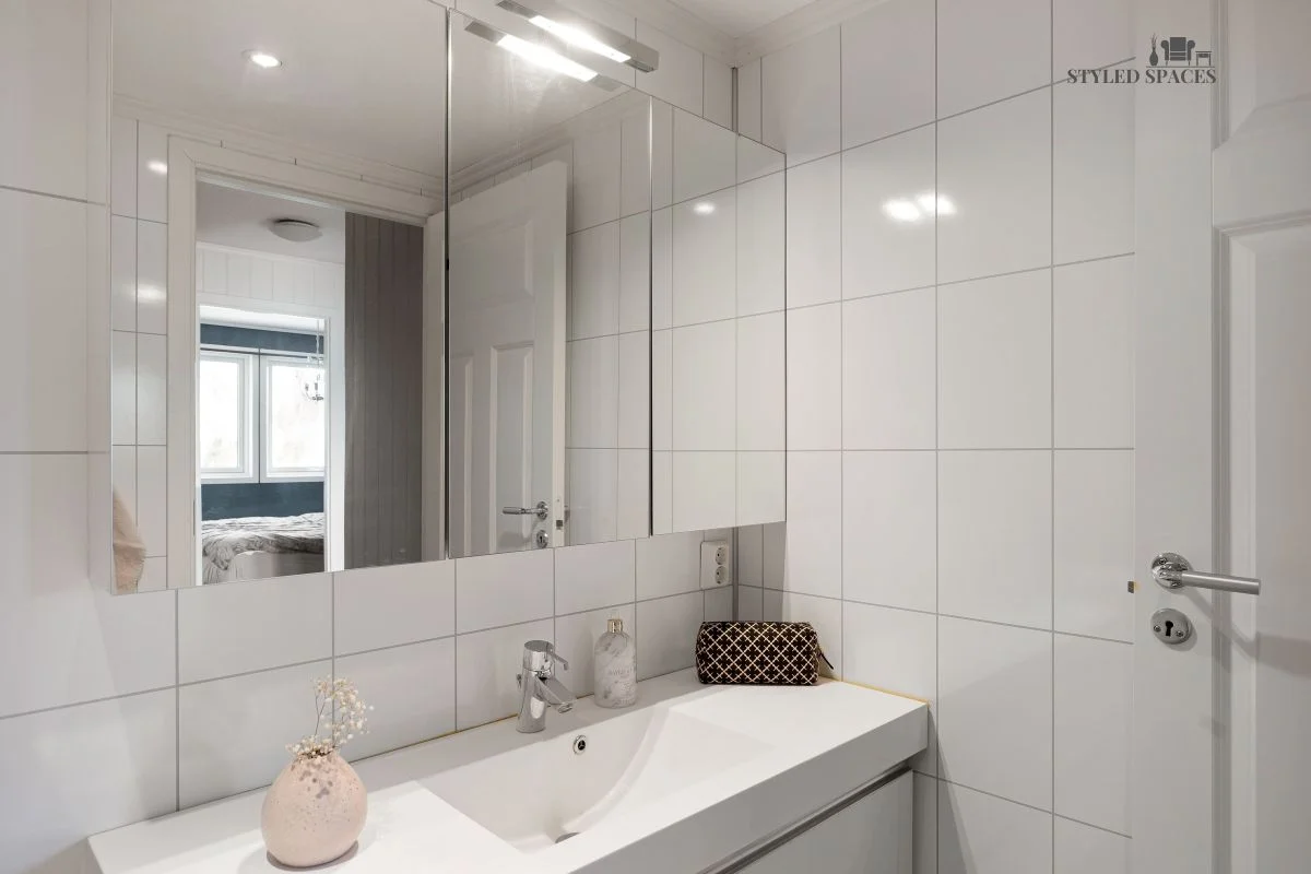 Recessed medicine cabinet with a custom-framed mirror front