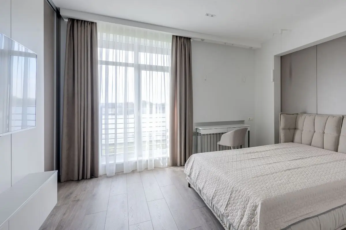 Floor-length curtains framing a bedroom window
