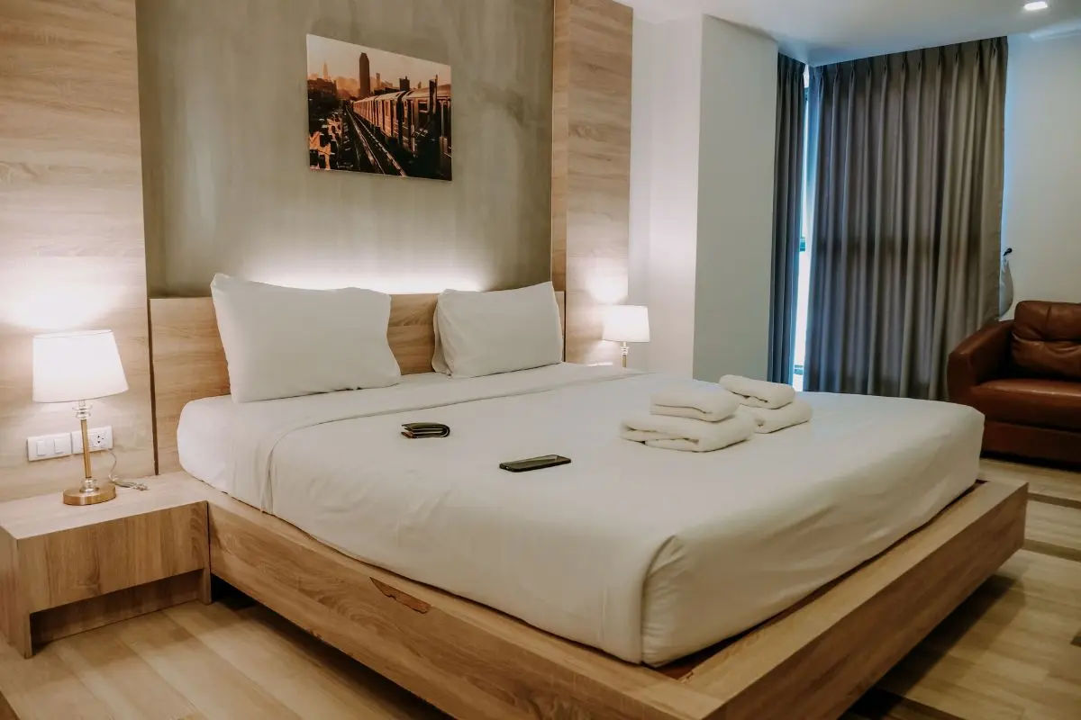 Bedroom with layered lighting from nightstand lamps and a wall sconce