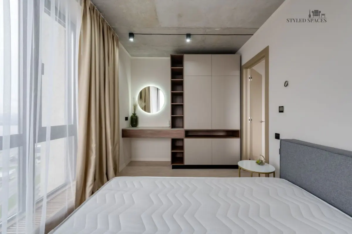 Bedroom storage ottoman and hidden cabinetry keeping clutter out of sight
