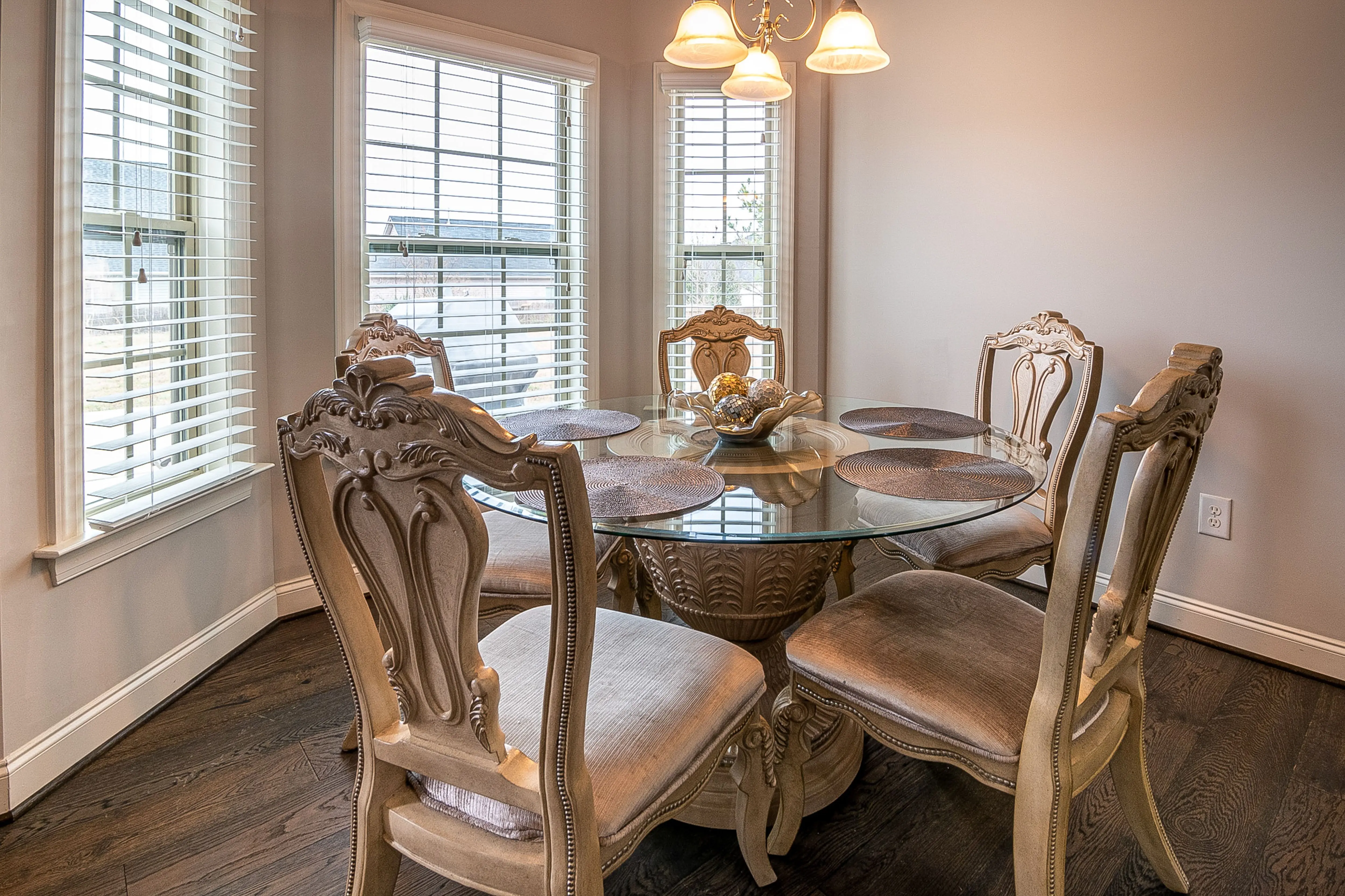 Glass-top dining table keeping a compact room feeling light and open