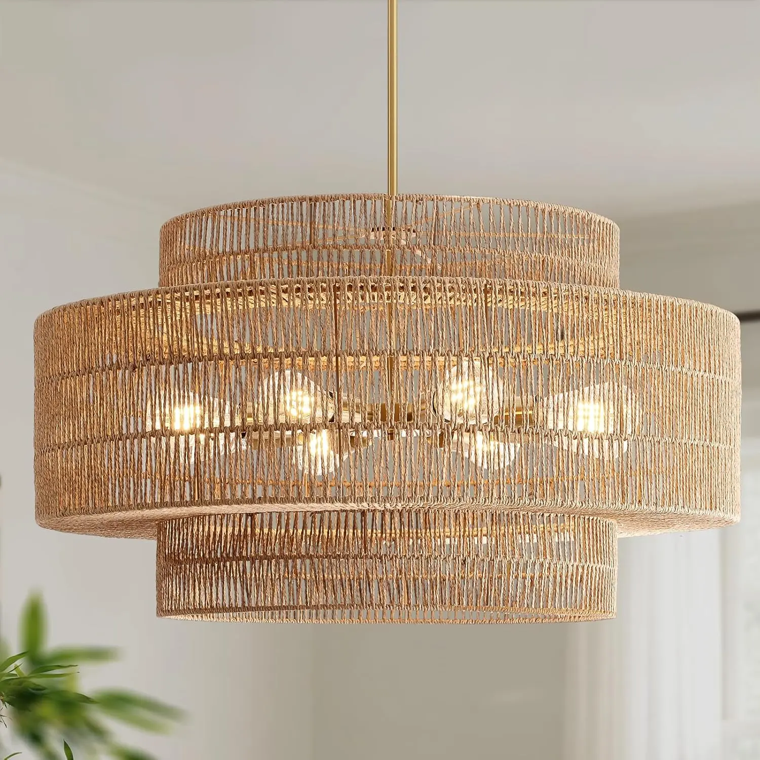 InterMaka large hand-woven jute tiered pendant chandelier over a table