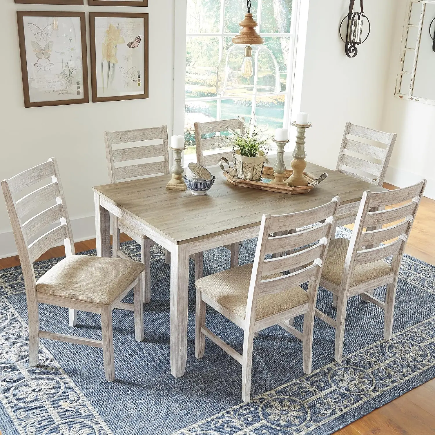 Ashley Skempton whitewashed farmhouse dining table with six ladder-back chairs on a blue rug