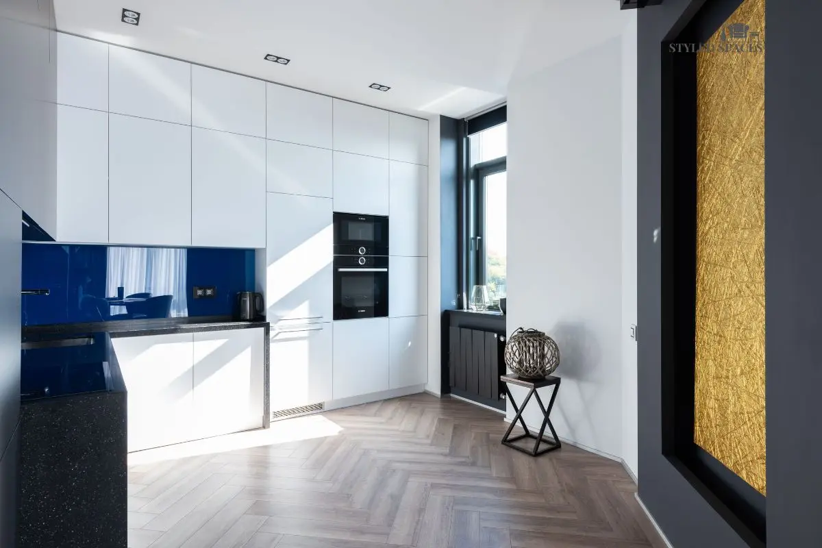 Kitchen with neutral cabinets and a bold, saturated wall color