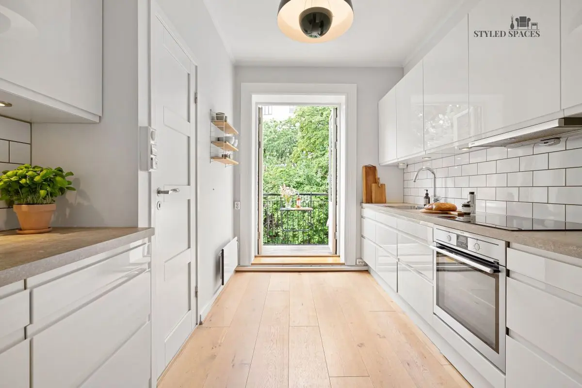 Narrow galley kitchen opened up with a window bump-out and breakfast nook