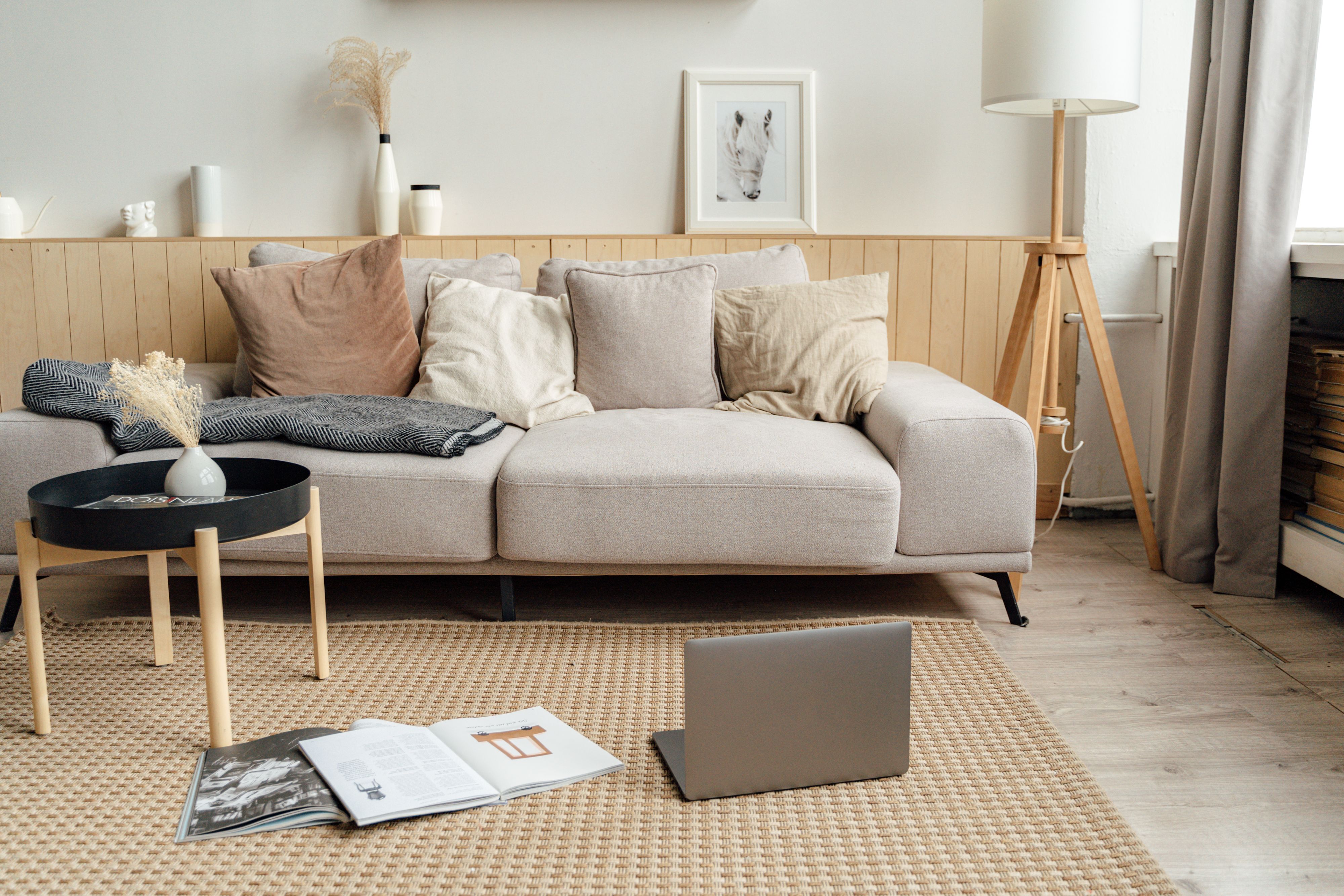 Bright, layered living room with a linen sofa, warm pillows, and natural light