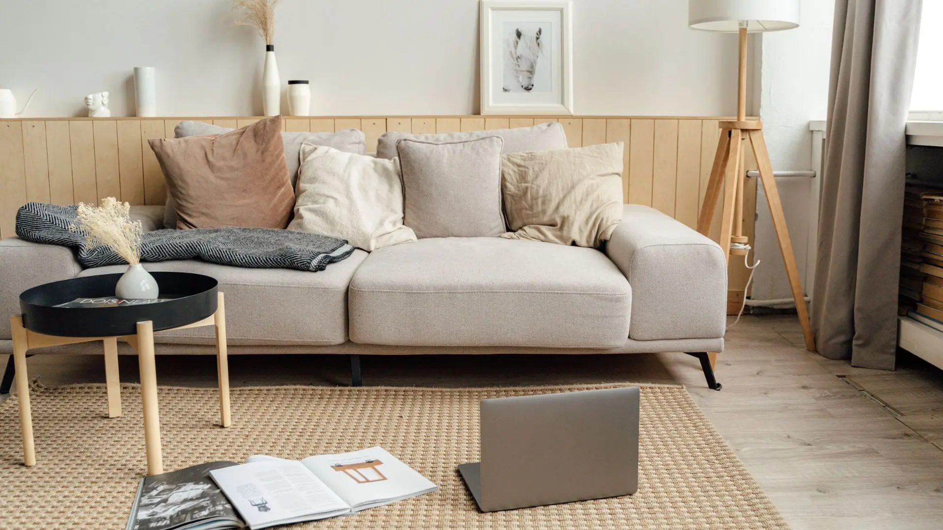 Bright, layered living room with a linen sofa, warm pillows, and natural light