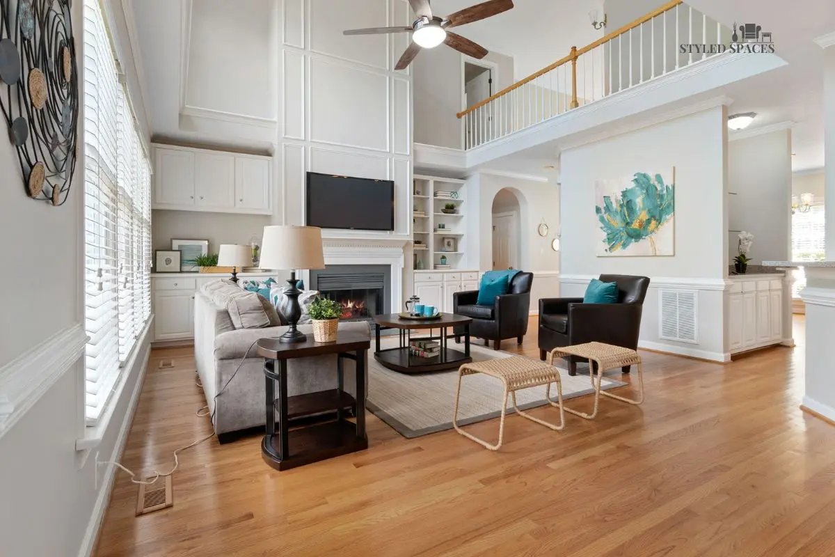 Tall, open living room grounded with oversized furniture and a large rug