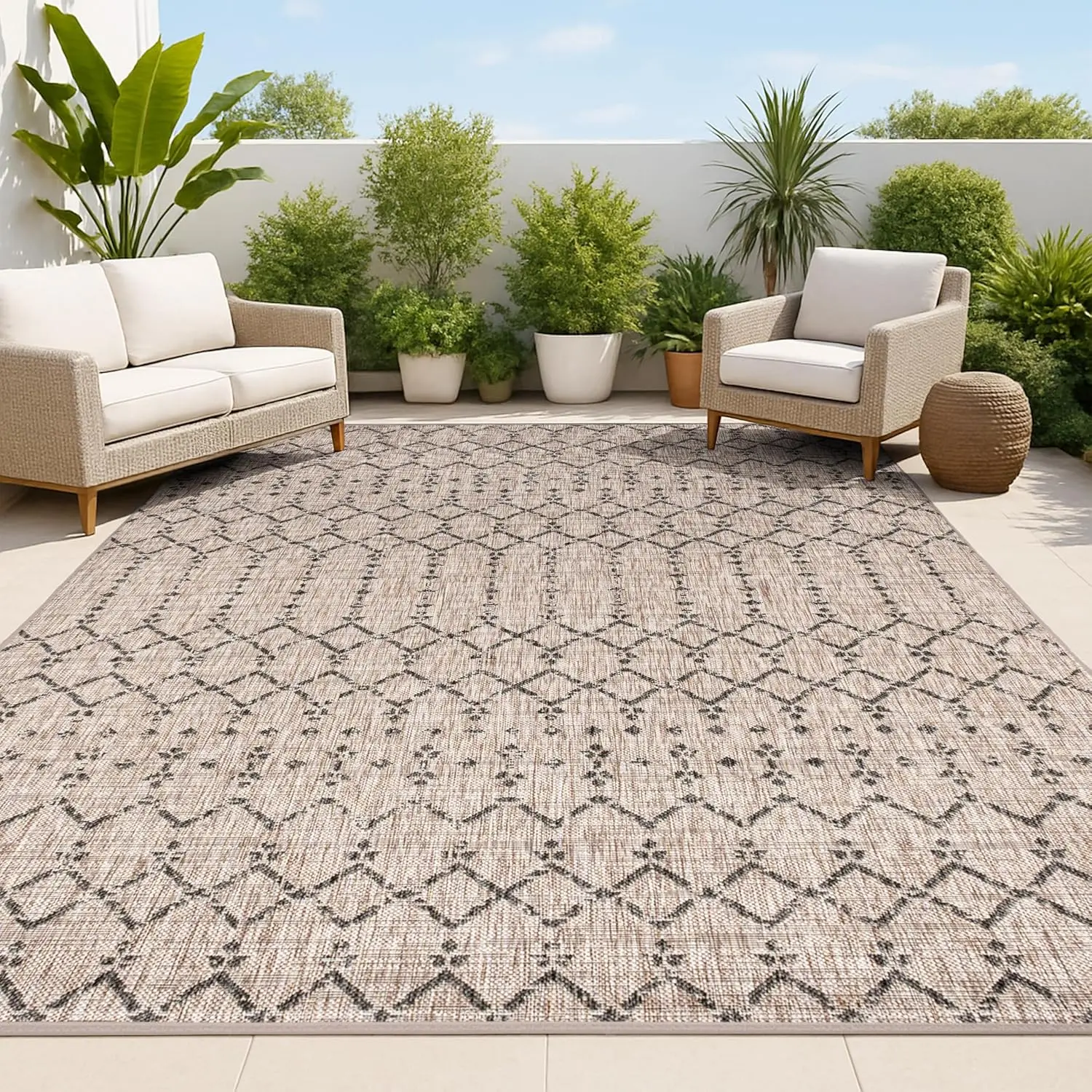 JONATHAN Y Moroccan geometric indoor outdoor rug in beige and gray on a patio