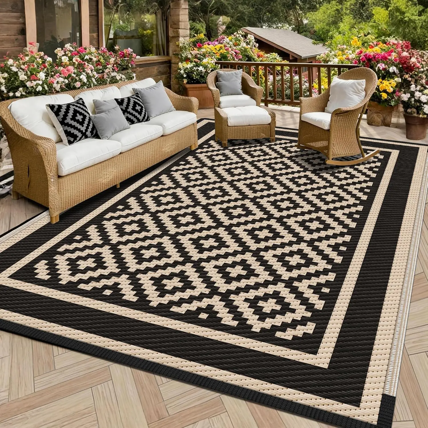 Kohree reversible plastic outdoor rug in black and cream diamond pattern