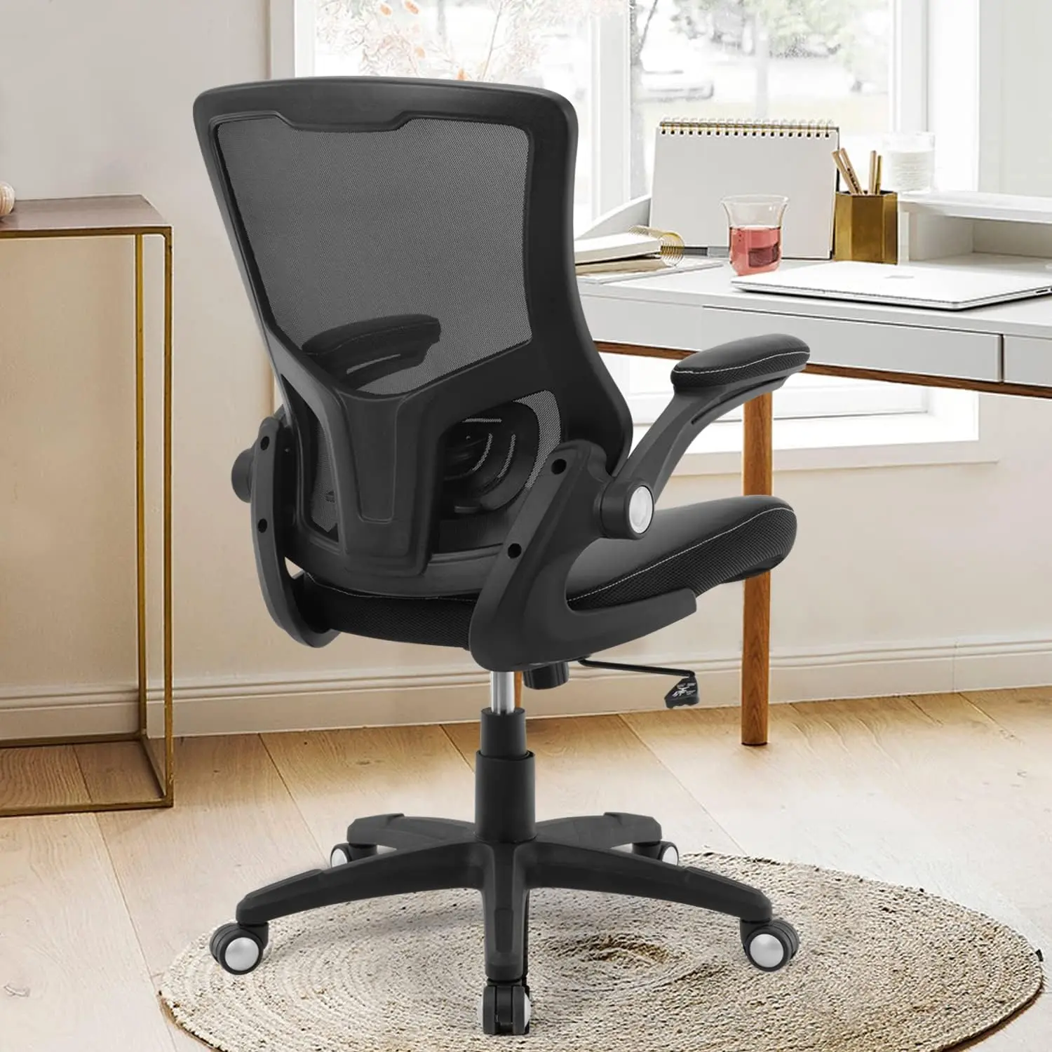 Ergonomic black mesh office chair with flip-up armrests