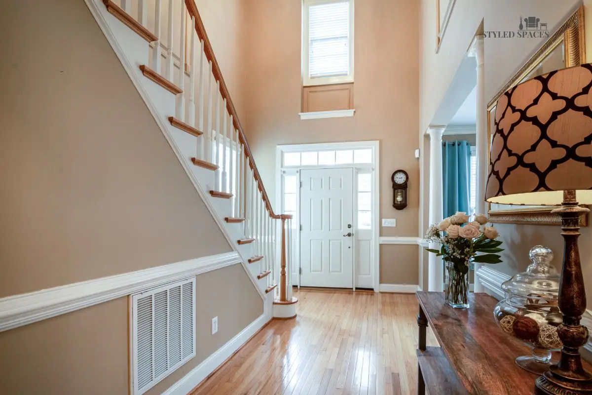 Entryway landing zone with a console, mirror, and storage for keys and shoes