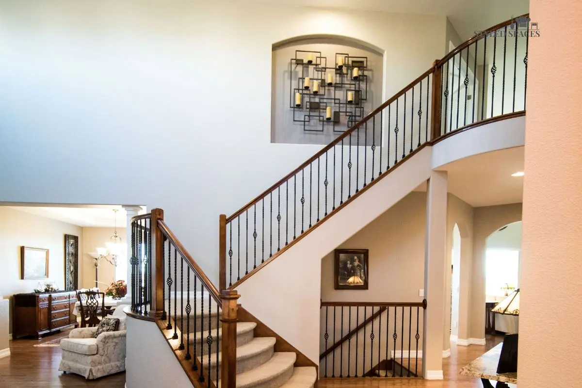 Staircase wall anchored with one large statement art piece