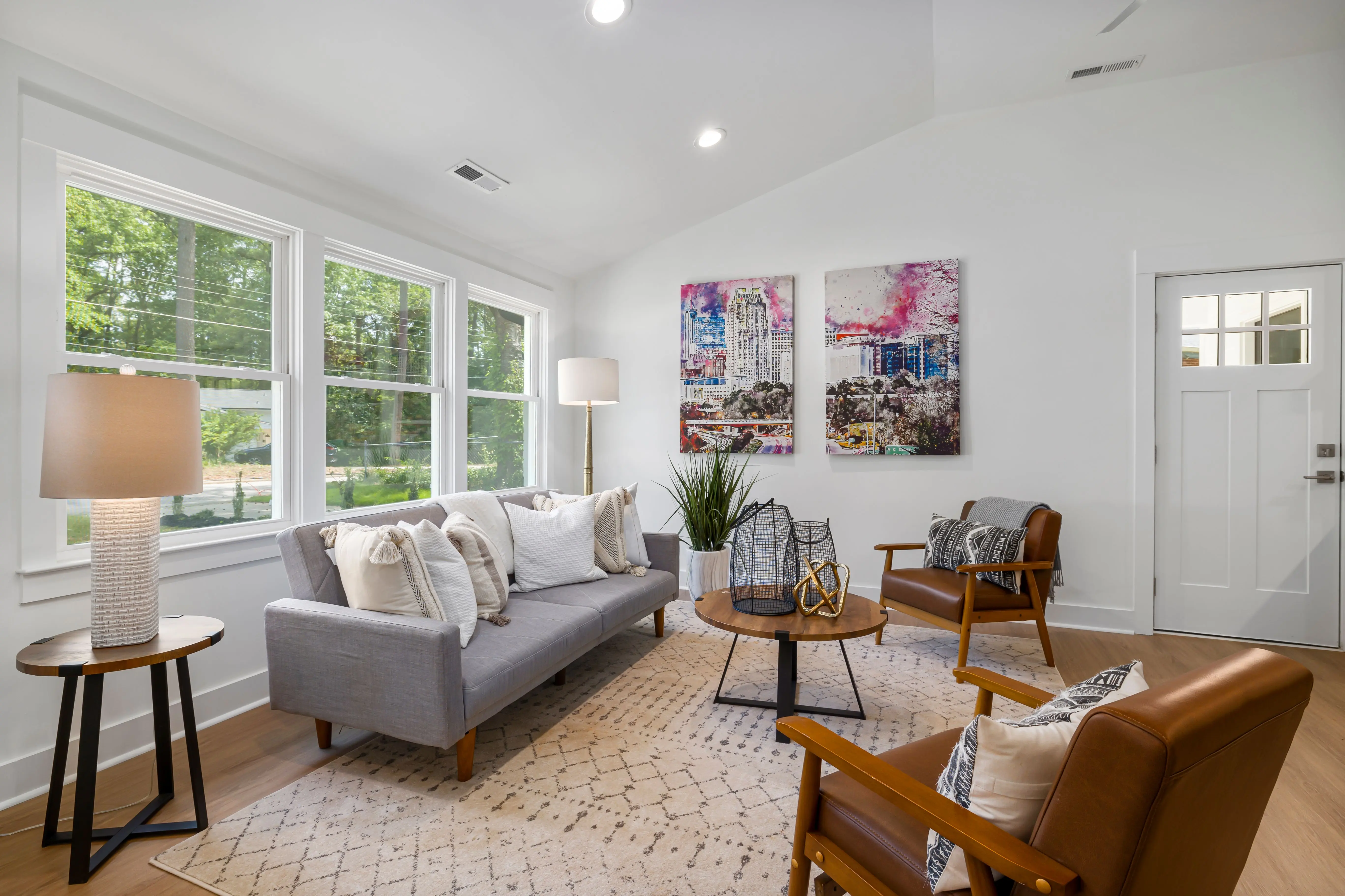Living room chairs and sofa on slim exposed legs