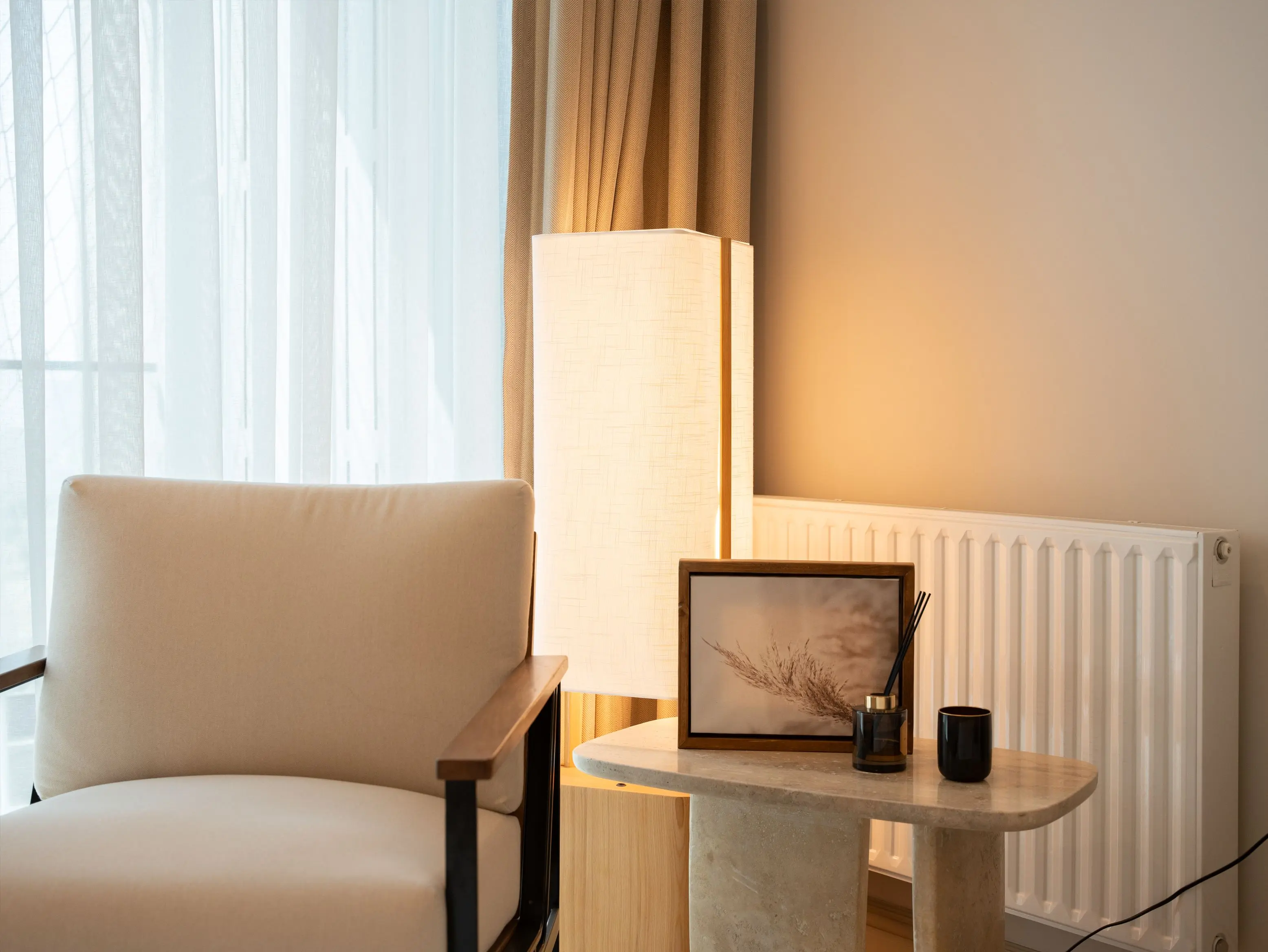 Layered lighting from a floor lamp and table lamp in a living room